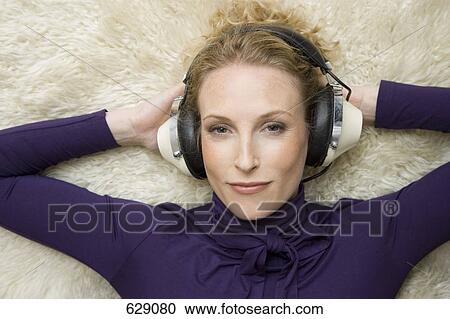 A woman wearing old-fashioned headphones View Large Photo Image Stock Image - A woman wearing old-fashioned headphones. Fotosearch