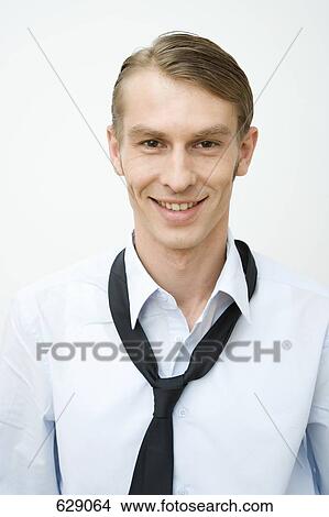 Picture - Portrait of a mid adult man wearing a loose tie. Fotosearch