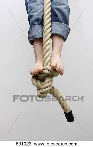 A child standing on a rope swing View Large Photo Image Stock Image - A child standing on a rope swing. Fotosearch