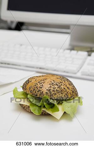 Stock Photograph - A lettuce and cheese sandwich on a poppy seed bun. Fotosearch