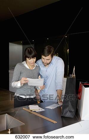 A man and a woman reading a letter View Large Photo Image Stock Photo - A man and a woman reading a letter. Fotosearch