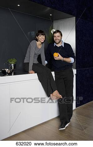 A man and a woman relaxing at home View Large Photo Image Stock Image - A man and a woman relaxing at home. Fotosearch