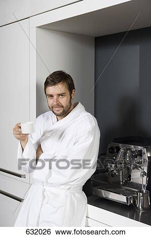 A man in a bathrobe holding a coffee cup View Large Photo Image Stock Photograph - A man in a bathrobe holding a coffee cup. Fotosearch