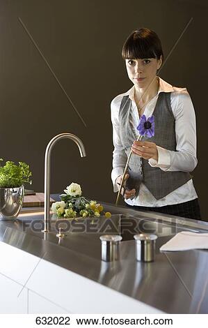 A woman pruning cut flowers View Large Photo Image Stock Image - A woman pruning cut flowers. Fotosearch