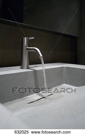 Close-up of a faucet with running water View Large Photo Image Stock Photography - Close-up of a faucet with running water. Fotosearch