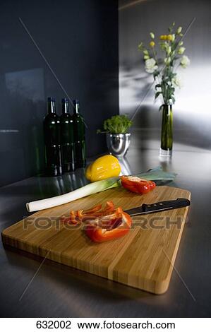 Still life of a cutting board with a kitchen knife and vegetables in a domestic kitchen View Large Photo Image Stock Image - Still life of a cutting board with a kitchen knife and vegetables in a domestic kitchen. Fotosearch