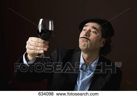 A stereotypical French man staring at a glass of red wine View Large Photo Image Stock Photo - A stereotypical French man staring at a glass of red wine. Fotosearch