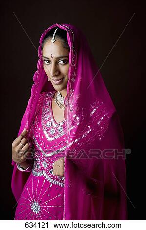 A woman dressed in traditional Indian clothing View Large Photo Image Stock Image - A woman dressed in traditional Indian clothing. Fotosearch