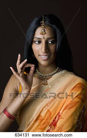 A woman dressed in traditional Indian clothing View Large Photo Image Stock Image - A woman dressed in traditional Indian clothing. Fotosearch