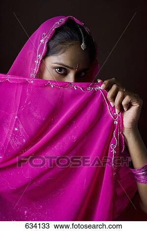 A woman dressed in traditional Indian clothing View Large Photo Image Stock Image - A woman dressed in traditional Indian clothing. Fotosearch