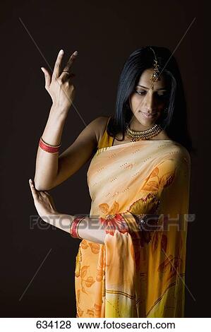 A woman dressed in traditional Indian clothing View Large Photo Image Stock Photo - A woman dressed in traditional Indian clothing. Fotosearch