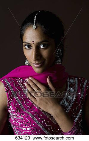 A woman dressed in traditional Indian clothing View Large Photo Image Stock Photo - A woman dressed in traditional Indian clothing. Fotosearch