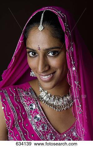 A woman dressed in traditional Indian clothing View Large Photo Image Stock Photo - A woman dressed in traditional Indian clothing. Fotosearch