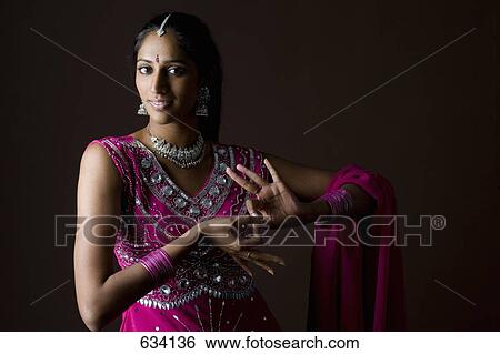 A woman dressed in traditional Indian clothing View Large Photo Image Stock Photograph - A woman dressed in traditional Indian clothing. Fotosearch