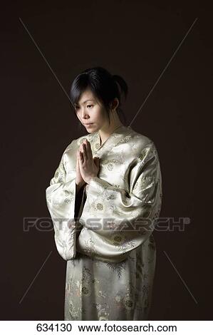A woman in a kimono bowing View Large Photo Image Stock Image - A woman in a kimono bowing. Fotosearch