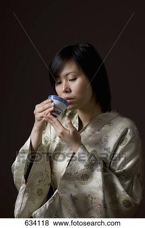 A woman in a kimono drinking tea View Large Photo Image Stock Photo - A woman in a kimono drinking tea. Fotosearch