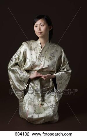 A woman in a kimono kneeling View Large Photo Image Stock Image - A woman in a kimono kneeling. Fotosearch