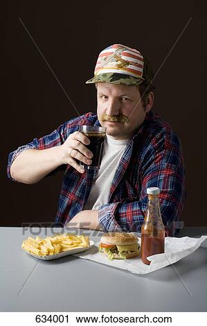 Stereotypical American man with burger, fries and a cola View Large Photo Image Stock Image - Stereotypical American man with burger, fries and a cola. Fotosearch