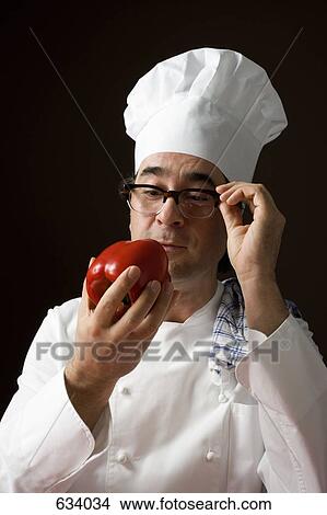 Stereotypical chef staring at a red bell pepper View Large Photo Image Picture - Stereotypical chef staring at a red bell pepper. Fotosearch
