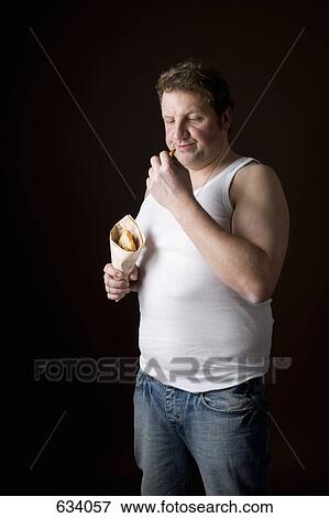 Stereotypical Englishman frowning at a chip View Large Photo Image Stock Photo - Stereotypical Englishman frowning at a chip. Fotosearch