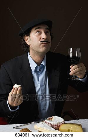 Stereotypical French man with French cheese and a glass of red wine View Large Photo Image Stock Image - Stereotypical French man with French cheese and a glass of red wine. Fotosearch