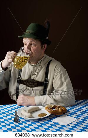 Stereotypical German man in Bavarian costume drinking a beer and German meal View Large Photo Image Stock Photo - Stereotypical German man in Bavarian costume drinking a beer and German meal. Fotosearch