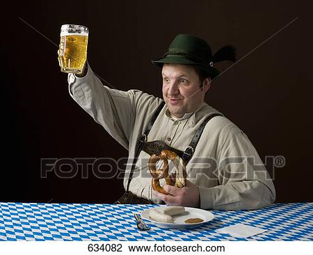 Stereotypical German man, smiling and raising a beer View Large Photo Image Stock Image - Stereotypical German man, smiling and raising a beer. Fotosearch