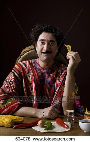 Stereotypical Mexican man with Mexican ingredients eating a tortilla chip View Large Photo Image Stock Photo - Stereotypical Mexican man with Mexican ingredients eating a tortilla chip. Fotosearch