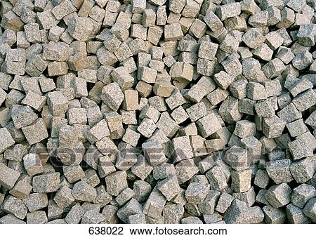 Stock Image - A pile of loose granite setts. Fotosearch