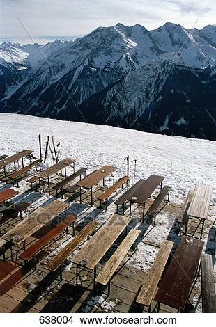 Tables and chairs overlooking a mountain range, Austria View Large Photo Image Picture - Tables and chairs overlooking a mountain range, Austria. Fotosearch