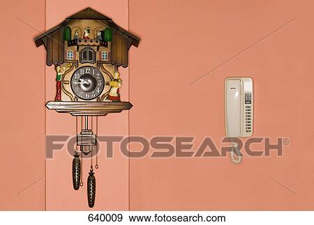 A cuckoo clock and a telephone on a wall View Large Photo Image Stock Photo - A cuckoo clock and a telephone on a wall. Fotosearch