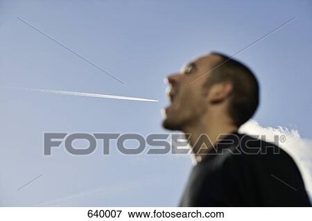 An aeroplane flying into a man’s mouth View Large Photo Image Stock Photo - An aeroplane flying into a man’s mouth. Fotosearch