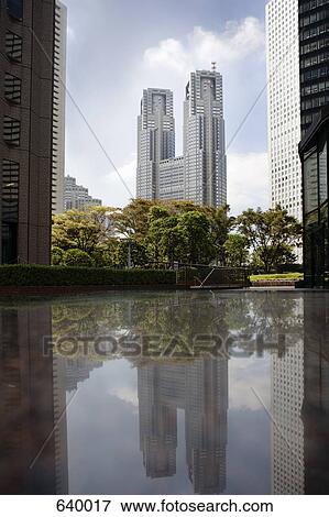 Skyscrapers reflecting on a pond in Tokyo, Japan View Large Photo Image Stock Photo - Skyscrapers reflecting on a pond in Tokyo, Japan. Fotosearch