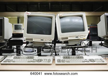 Stock Image - Two old computers with ‘Fired’ labels. Fotosearch