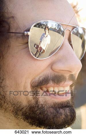A skateboarder reflected in a friend’s sunglasses View Large Photo Image Stock Image - A skateboarder reflected in a friend’s sunglasses. Fotosearch
