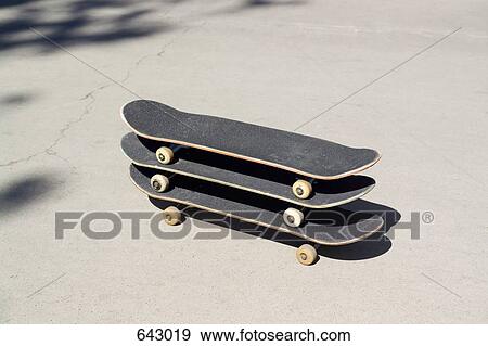 Stock Photo - Three skateboards stacked on tope of each other. Fotosearch