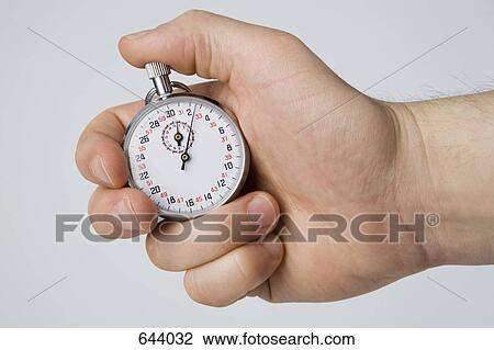 A hand holding a stopwatch View Large Photo Image Stock Image - A hand holding a stopwatch. Fotosearch