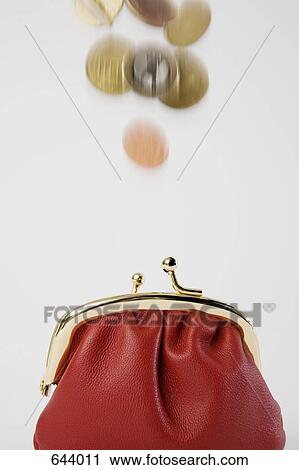 Stock Image - Coins falling into a purse. Fotosearch