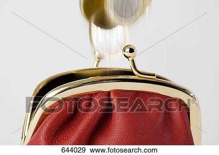Coins falling into a purse View Large Photo Image Stock Photo - Coins falling into a purse. Fotosearch