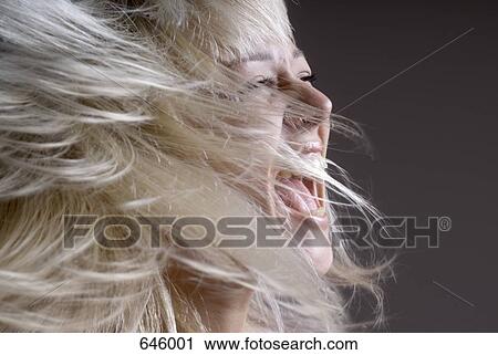 A woman tossing her hair with her mouth open View Large Photo Image Stock Image - A woman tossing her hair with her mouth open. Fotosearch