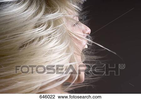 A woman tossing her hair with her mouth open View Large Photo Image Stock Image - A woman tossing her hair with her mouth open. Fotosearch