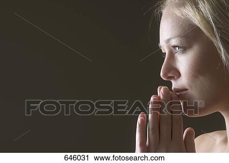 Profile of a woman praying View Large Photo Image Stock Image - Profile of a woman praying. Fotosearch