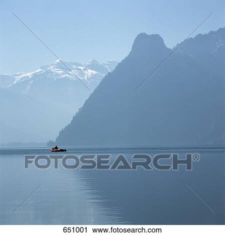 Stock Image - Unrecognizable Person in an Inflatable Raft, Traunsee, Salzkammergut, Austria. Fotosearch