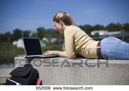 A University student using a laptop View Large Photo Image Stock Photo - A University student using a laptop. Fotosearch