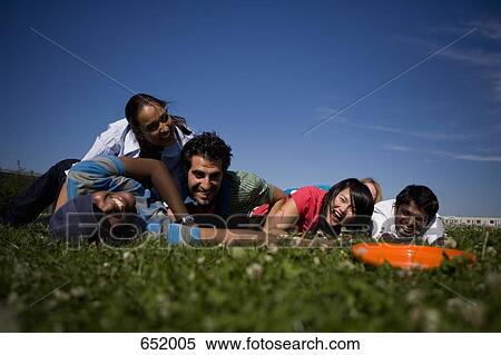 Stock Photography - University students playing Frisbee on campus. Fotosearch
