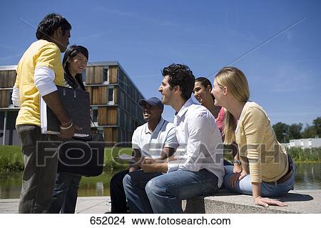University students socializing and studying on campus View Large Photo Image Picture - University students socializing and studying on campus. Fotosearch