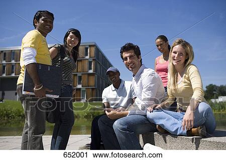 University students socializing and studying on campus View Large Photo Image Stock Image - University students socializing and studying on campus. Fotosearch