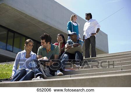 University students socializing and studying on outdoor campus stairs View Large Photo Image Stock Photograph - University students socializing and studying on outdoor campus stairs. Fotosearch