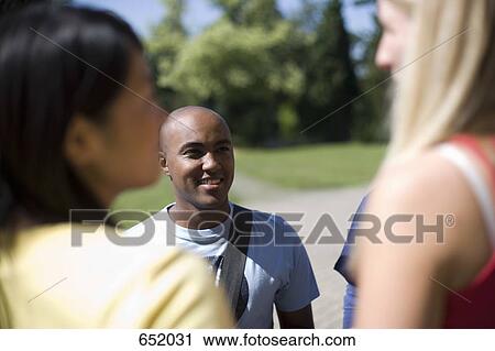 University students socializing on campus View Large Photo Image Stock Image - University students socializing on campus. Fotosearch