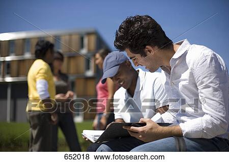 Stock Photo - University students studying on campus. Fotosearch
